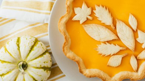 baked pumpkin pie with decorative leafy patterns design