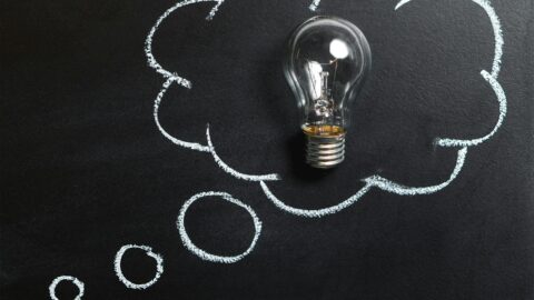 clear light bulb placed on chalkboard